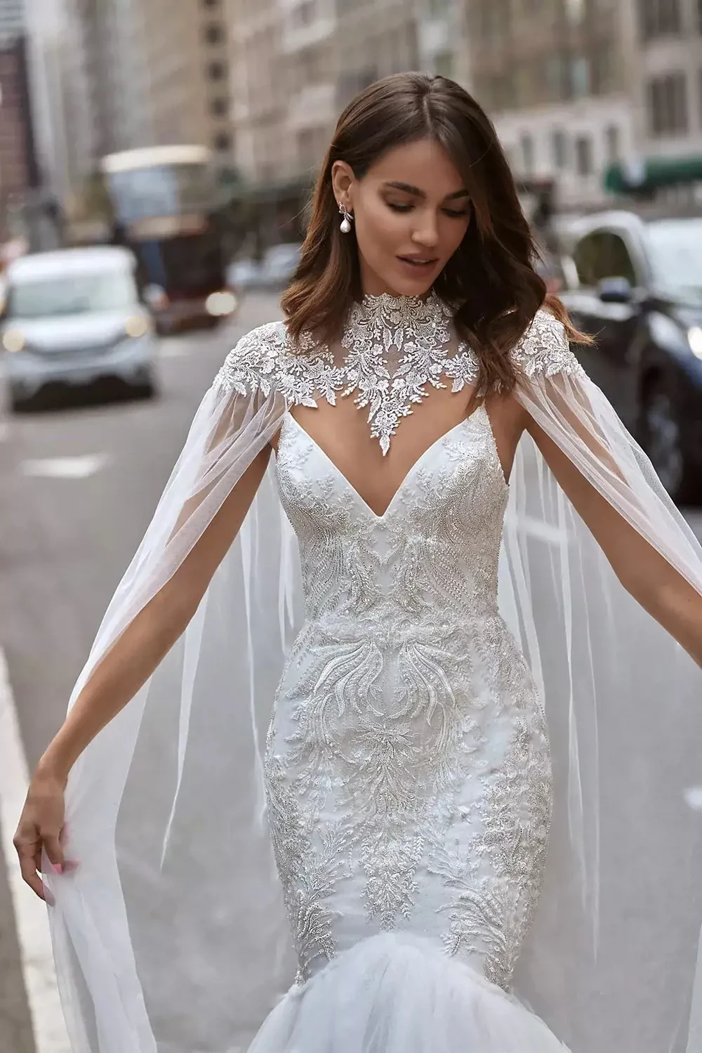 Eva's Bridals International — beaded gown with a high-neck cape, photographed in the city